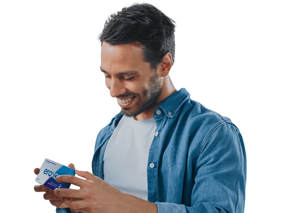A man holding a box of Eroxon erectile dysfunction treatment and smiling.